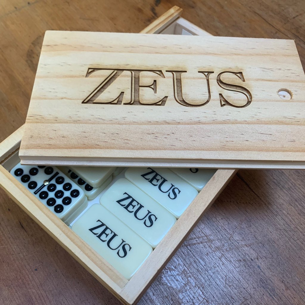 Pine box with an engraved name and matching tiles